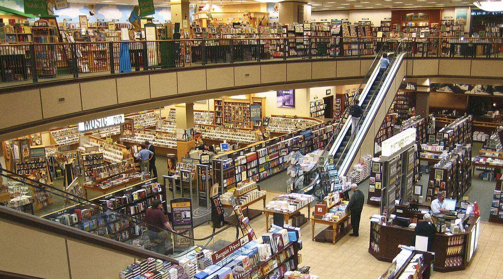 Bookshelves and escalators inside a multilevel Barnes & Noble bookstore