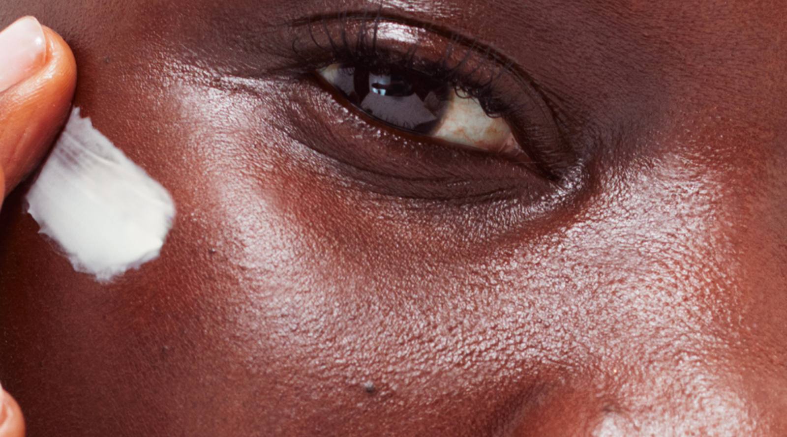 Close-up of an eye and skin in Glossier skincare imagery